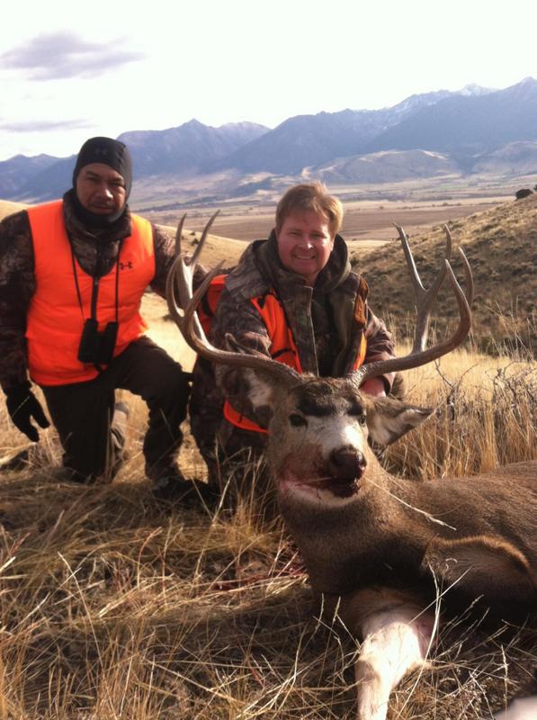 Two hunters with a large deer
