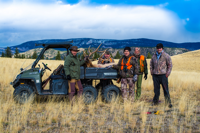 Group of hunters with large elk